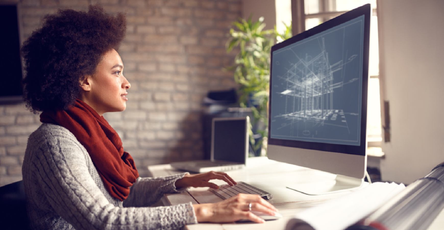 Professional at their work computer reviewing architectural drawings.