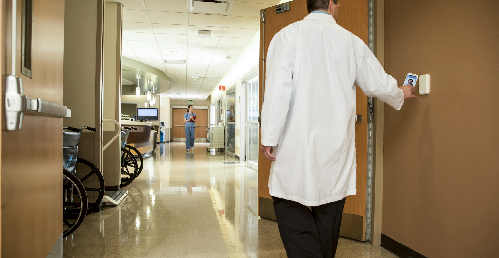 A doctor using a mobile credential to access a healthcare space.