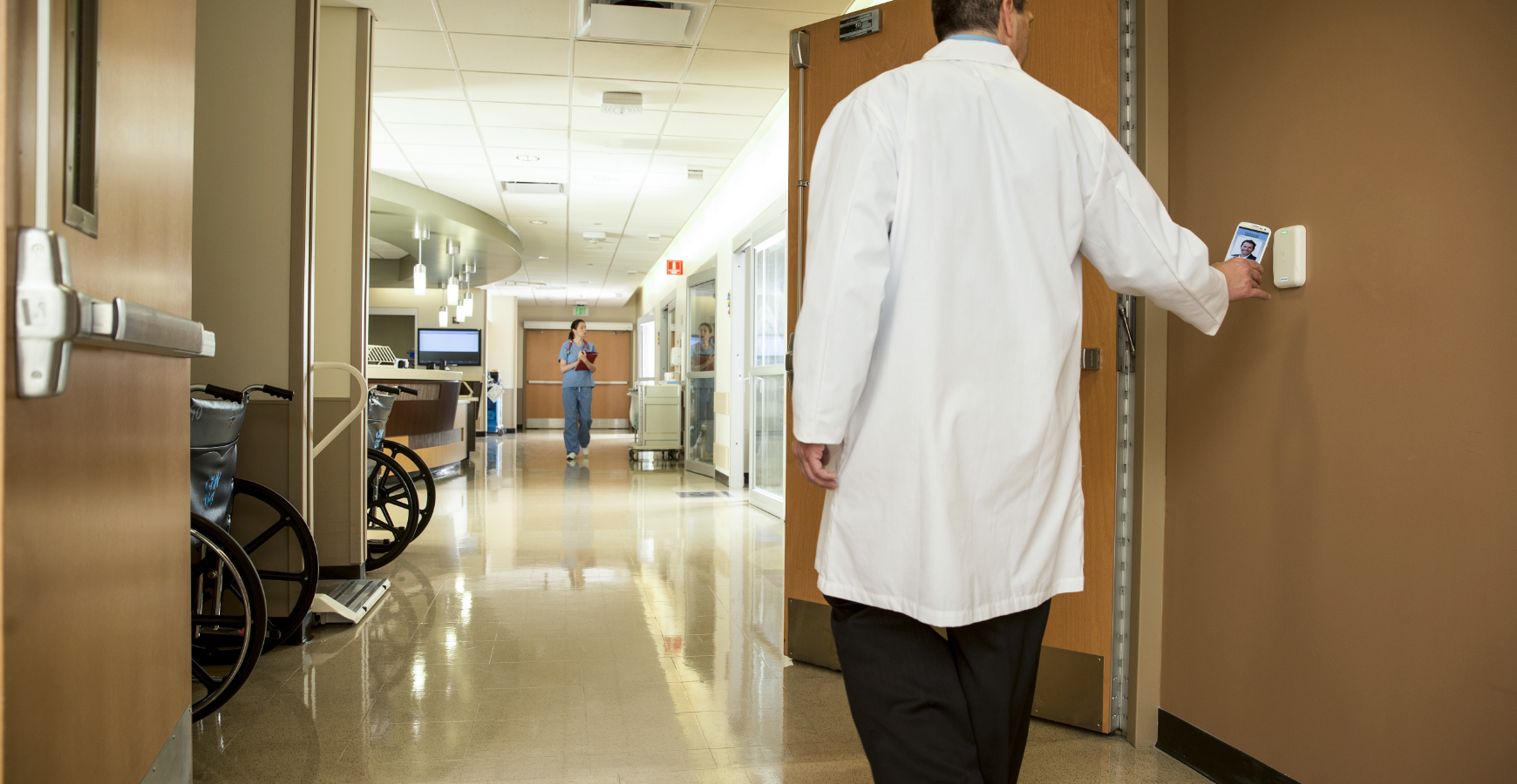 A doctor using a mobile credential to access a healthcare space. 