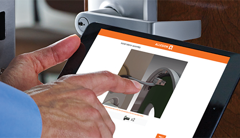 Close up hands using a tablet displaying Allegion's Interactive Instruction manual. 